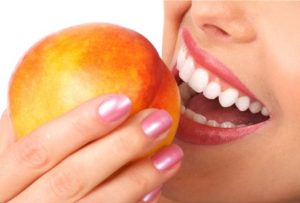 dental smile biting a peach