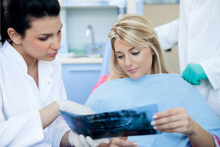 dentist - patient consult over dental procedures 